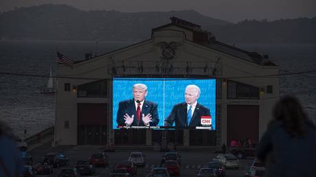 FILE PHOTO: People watch the final US presidential debate between President Donald Trump and Democratic candidate Joe Biden.