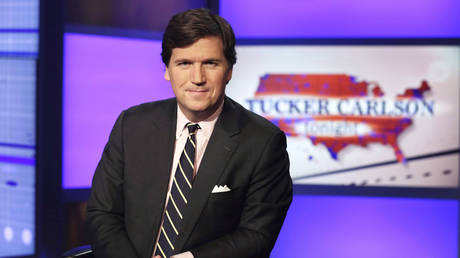 FILE PHOTO: Tucker Carlson, host of 'Tucker Carlson Tonight', poses for photos in a Fox News Channel studio.