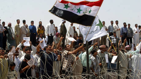 FILE PHOTO: Thousands of Iraqis demonsrtate in front of the Abu Ghraib prison on May 5, 2004.