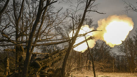 FILE PHOTO: Ukrainian servicemen fire an M777 howitzer at Russian positions near Artyomovsk (Bakhmut), March 17, 2023.