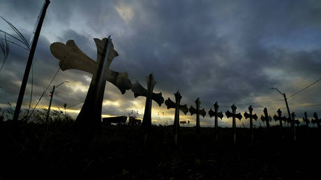 Crosses along a highway  honor the victims of a school shooting at Robb Elementary School in Uvalde, Texas, June 3, 2022