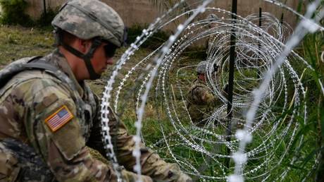 FILE PHOTO: US Army soldiers lay down razor wire while working alongside Customs and Border Protection agents, near the US-Mexico border in Hidalgo, Texas.