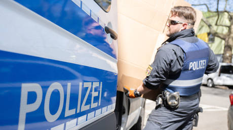 A police officer unloads a van with seized material from a raid in several German states against the Italian Mafia 'Ndrangheta on 3 May 2023 in Rhineland-Palatinate, Mainz