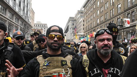 Enrique Tarrio (L) and Joe Biggs lead a crowd of Proud Boys and allies protesting the 2020 election results