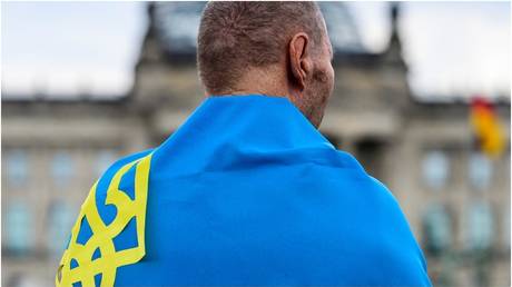 FILE PHOTO: A man wrapped in the Ukrainian flag in Berlin, 2022.