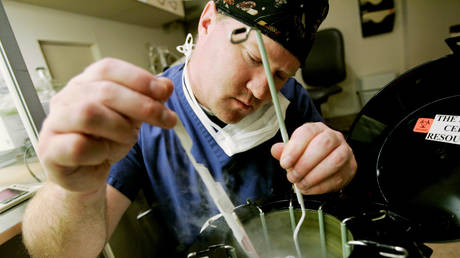 Embryologist Ric Ross pulls out vials of human embryos from a liquid Nitrogen storage container at the La Jolla IVF Clinic February 28, 2007 in La Jolla, California