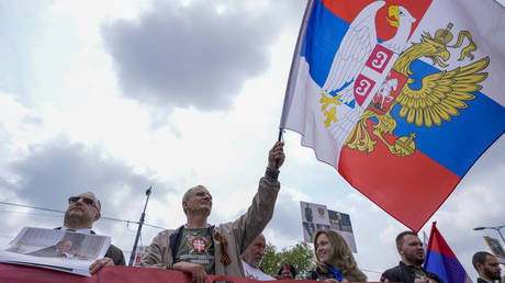 A man waves a flag that shows Russian and Serbian flags during the Immortal Regiment ceremony on the occasion of the 78th anniversary of the victory over Nazi Germany, in Belgrade, Serbia, May 9, 2023