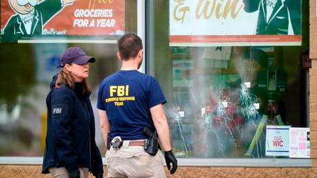 FILE PHOTO: Investigators work the scene of a shooting at a supermarket in Buffalo, New York, May 16, 2022.