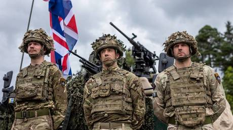 British soldiers stand in front of a military vehicle during a press conference of the Polish and Lithuanian president in north-eastern Poland, on July 7, 2022.