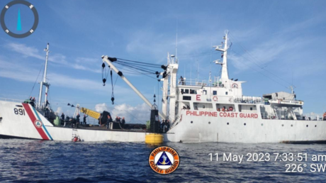 A Philippine Coast Guard crew is shown preparing to place a navigational buoy near the Spratly Islands on Thursday.