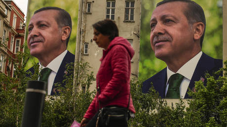 A woman walks past billboards of Recep Tayyip Erdogan a day after the presidential election in Istanbul, Türkiye, May 15, 2023