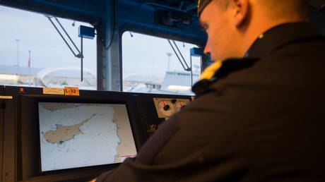 FILE PHOTO: A sailor looks at a map on the bridge of Norway's KNM Helge Ingstad during a January 2014 operation in the Eastern Mediterranean Sea.