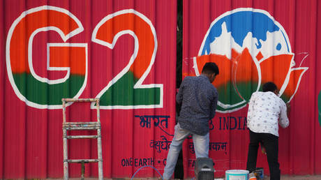 Artists paints G20 logo ahead of the G20 Foreign Ministers Meeting, in New Delhi, India