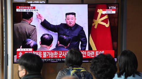 FILE PHOTO: People watch a television screen showing a news broadcast with file footage of North Korean leader Kim Jong-un, at a railway station in Seoul on April 13, 2023.