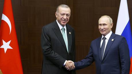 Vladimir Putin (R) and Recep Tayyip Erdogan shake hands during a meeting in Astana, Kazakhstan, October 13, 2022