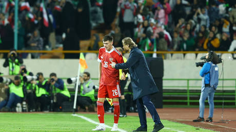 Head coach Valerii Karpin of Russia speaks with Khlusevich Daniil of Russia during the International Friendly between Iran and Russia at Azadi Stadium on March 23, 2023 in Tehran, Iran