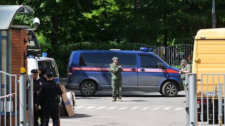 Employees of the Russian Investigative Committee are seen outside an apartment block following a reported drone attack in Moscow, Russia.