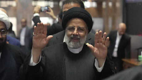 Iranian President Ebrahim Raisi waves at the media as he attends a mid-day prayer at Istiqlal Mosque in Jakarta, Indonesia, Wednesday, May 24, 2023.