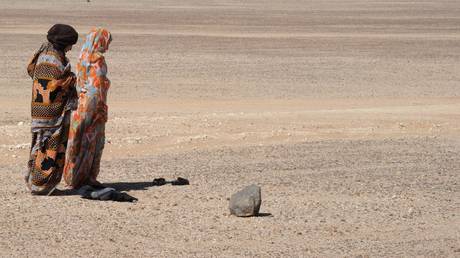 FILE PHOTO: Sahrawi women pray in the desert on February 26, 2011 between Tindouf and Tifariti in the Western Sahara.