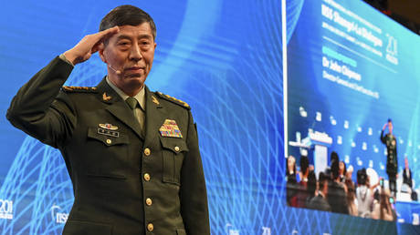 China's Minister of National Defence Li Shangfu salutes the audience before delivering a speech during a summit in Singapore.