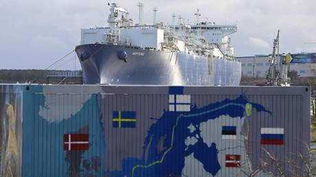 FILE PHOTO: Floating Storage and Regasification Unit (FSRU) Neptune is pictured behind a container painted with a map showing the Nord Stream 2 gas pipeline/