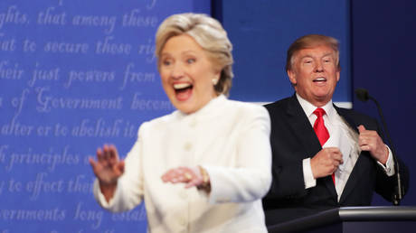 Hillary Clinton walks off stage as Donald Trump smiles after the third U.S. presidential debate at the Thomas & Mack Center on October 19, 2016 in Las Vegas, Nevada