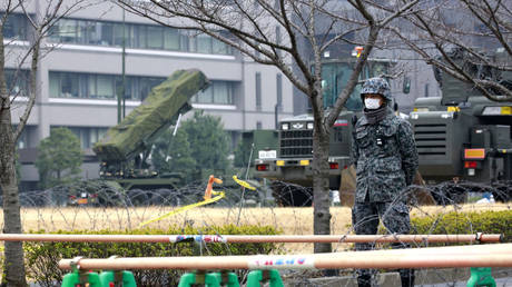 FILE PHOTO: A member of the Japan Self-Defense Forces stands by a PAC-3 Patriot missile unit deployed near the Defense Ministry in Tokyo, March 6, 2017