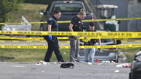 Police officers at the scene of a shooting in Willowbrook, Illinois, June 18, 2023.