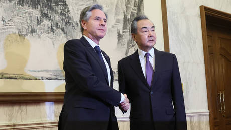 China's top diplomat Wang Yi shakes hands with US Secretary of State Antony Blinken during their meeting in Beijing.