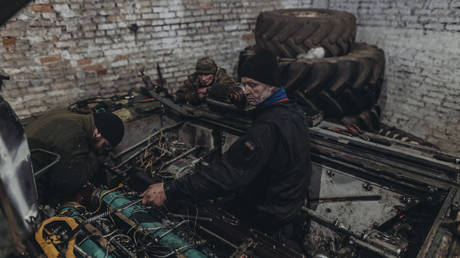 FILE PHOTO: Ukrainian army mechanics repair equipment at a hangar in Kharkov Region, March 18, 2023.