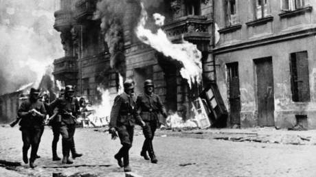 FILE PHOTO: German soldiers march through the burning streets of the Warsaw Ghetto, Poland, circa 1940.