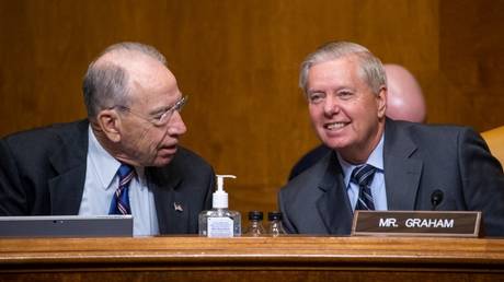 FILE PHOTO: Republican Senators Chuck Grassley (L) and Lindsey Graham attend a Senate committee hearing on Capitol Hill in Washington, DC, June 8, 2021.