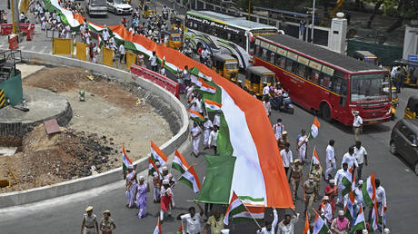 Members of India's Congress party carry a giant Indian national flag during the celebrations to mark country's 75th Independence Day in Chennai on August 15, 2022.