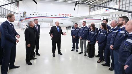 Russian Prime Minister Mikhail Mishustin (centre) meets the staff of the Kazan Aviation Factory, the manufacturer of Tu-214, on June 22, 2023.