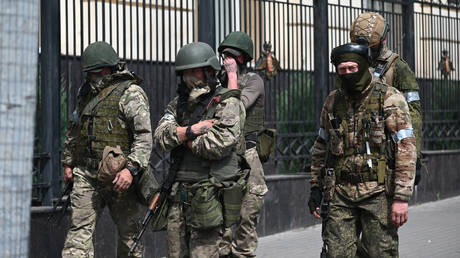 Servicemen of Russia's private military company Wagner Group are seen on a street in Rostov-on-Don, Russia.