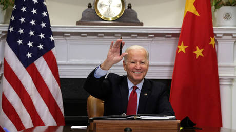 US President Joe Biden waves during a November 2021 virtual meeting with Chinese President Xi Jinping.