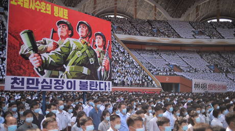 A banner that reads 'Tens of millions of people pledge to defy death for defending country!' is seen as residents of Pyongyang attend a mass rally to mark the 'day of struggle against US imperialism' on June 25, 2023.