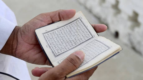 FILE PHOTO: A man reads the Koran.