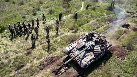 FILE PHOTO. A Ukrainian Army tank drives over an infantryman during a training exercise