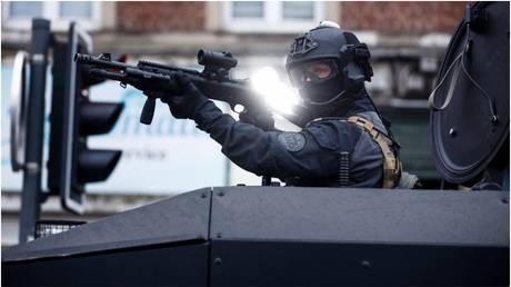 A police officer from the RAID unit holds a position in an anti-riot vehicle during protests in Lille, France, on June 29, 2023.