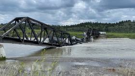 Train with chemicals slides into Montana river