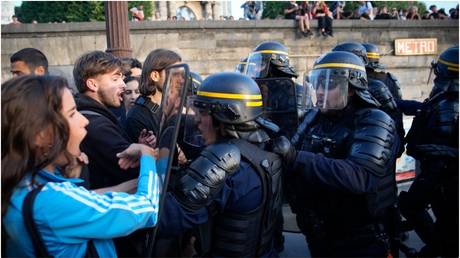 Police officers face protesters in Paris, on June 30, 2023.