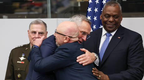 FILE PHOTO: Ukrainian Minister of Defence Aleksey Reznikov (C) hugs NATO Secretary General Jens Stoltenberg (2nd R) as senior US military officials look on.