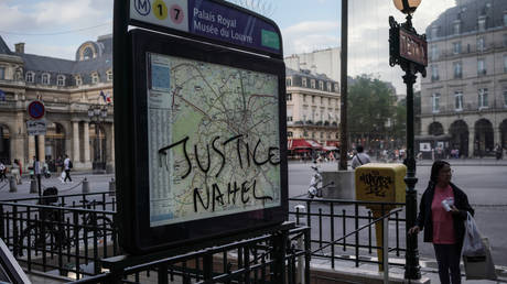 "Justice Nahel" is scrawled the Palais Royal Musee du Louvre metro sign on July 2, 2023 in Paris, France