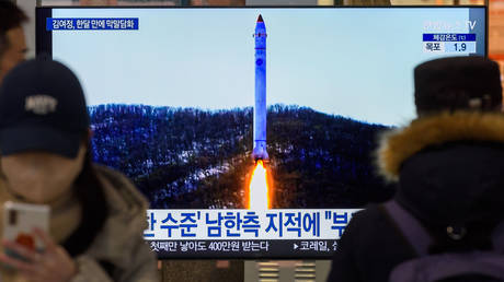 A TV screen shows image of North Korea's rocket with the test satellite during a news program at the Yongsan Railway Station in South Korea