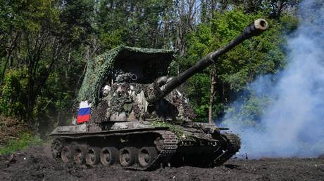 Russian servicemen fire from a Msta-S self-propelled howitzer towards Ukrainian positions.