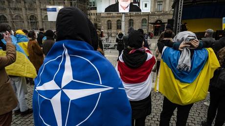 People draped in NATO and Ukrainian flags attend a rally in Berlin, Germany, March 6, 2022