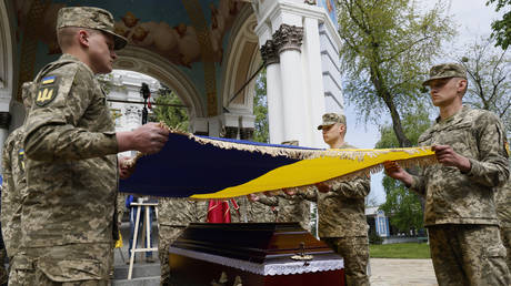 Ukrainian servicemen attend a farewell ceremony for an American soldier in Kiev, Ukraine, May 5, 2023