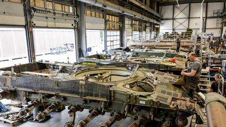 Technicians assemble a Leopard 2A4 battle tank at a Rheinmetall facility in Unterluess, Germany, June 6, 2023