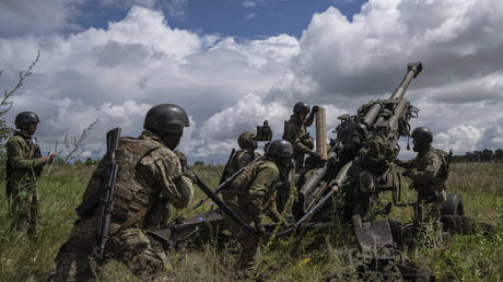 Ukrainian soldiers fire a US-made M777 howitzer in Kharkov Region, Ukraine, 2022.